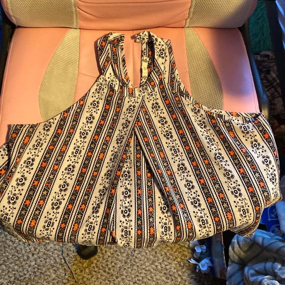 This is a halter neck top with flowers and a button back